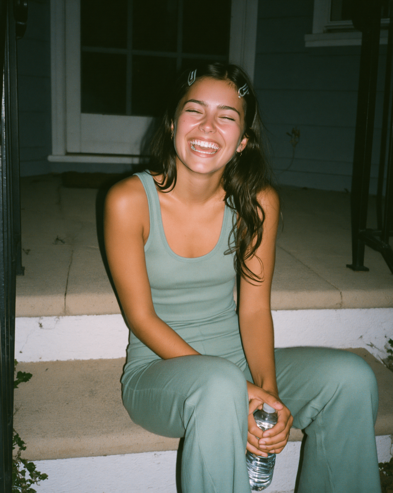 Sage cotton tank and flare on the porch steps — flash