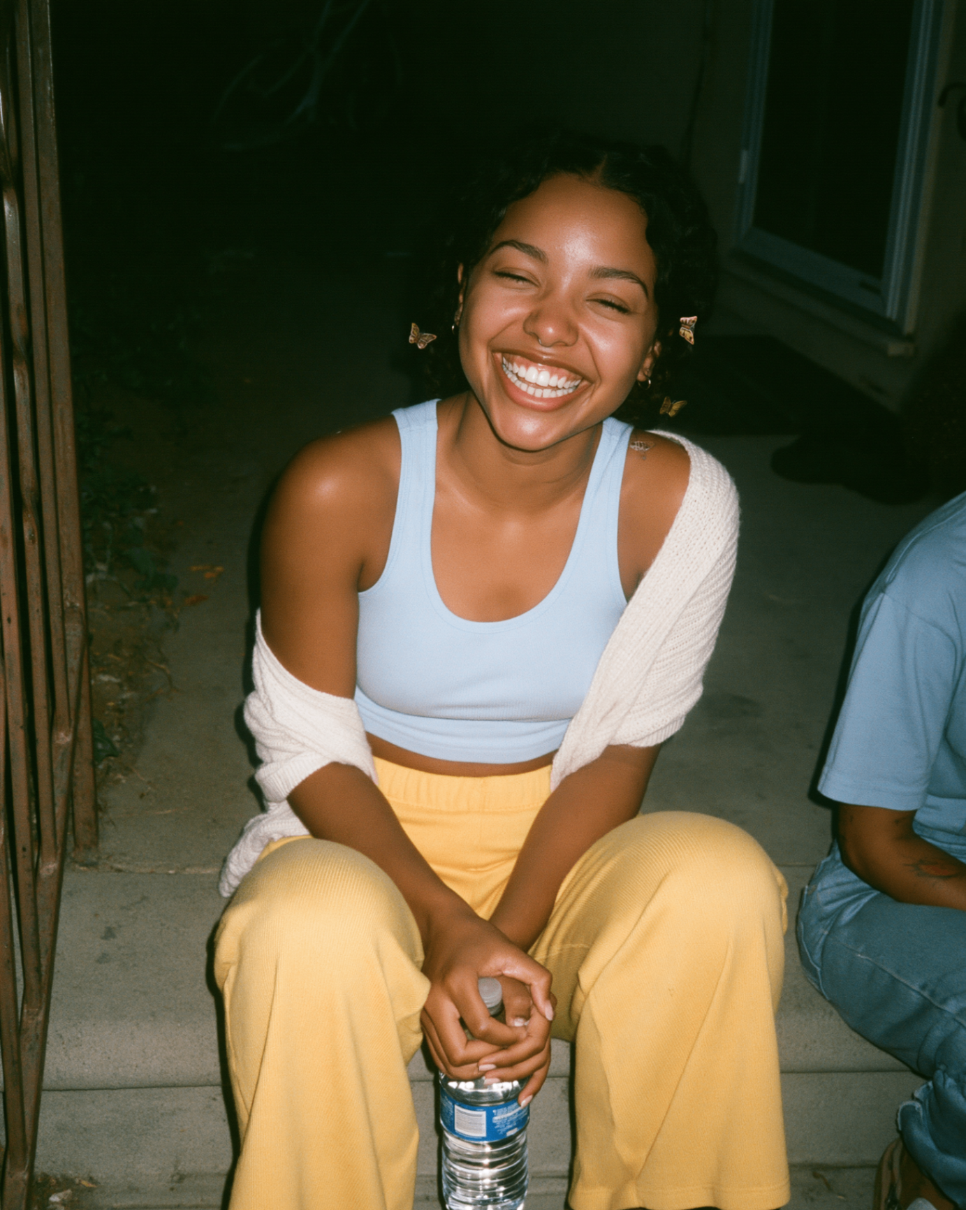 Powder blue tank and butter yellow flare on the steps — flash snapshot